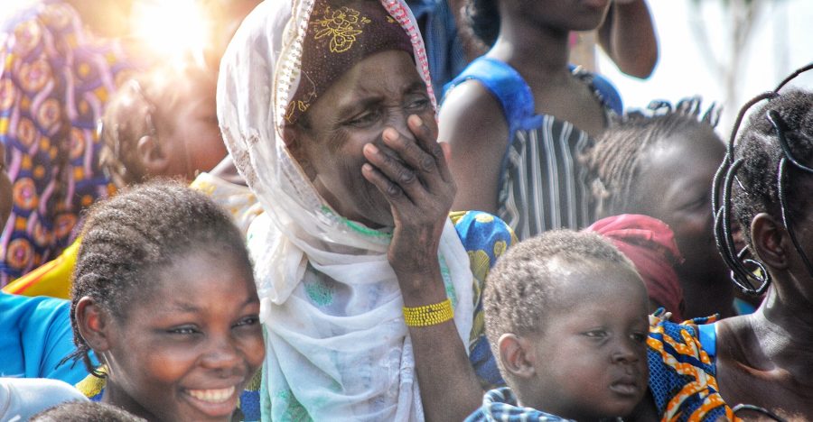African woman laughing in crowd - sunlight African woman laughing in crowd - sunlight