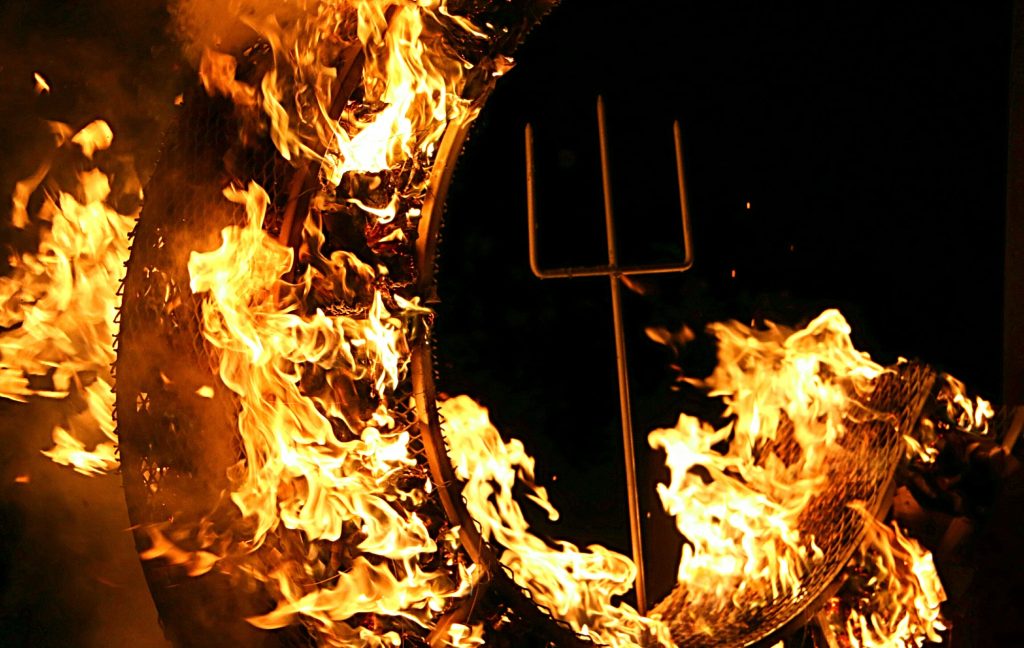 Devils Advocate: Pitchfork in the center of burning flames.